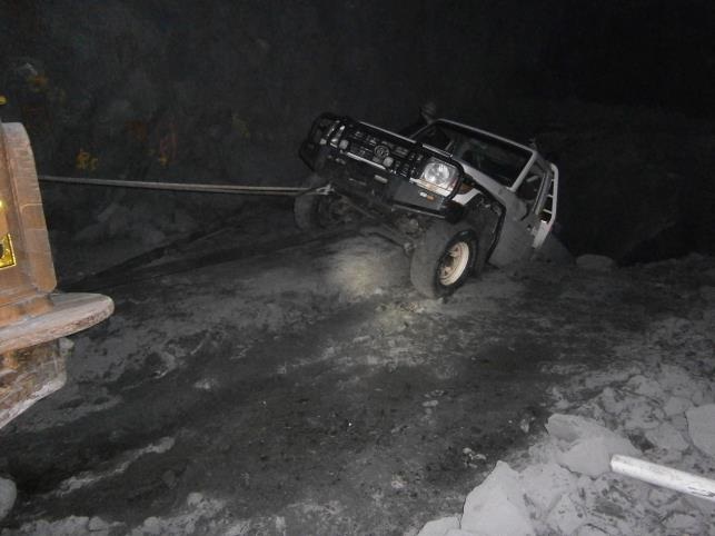 Light vehicle attached to loader with chain