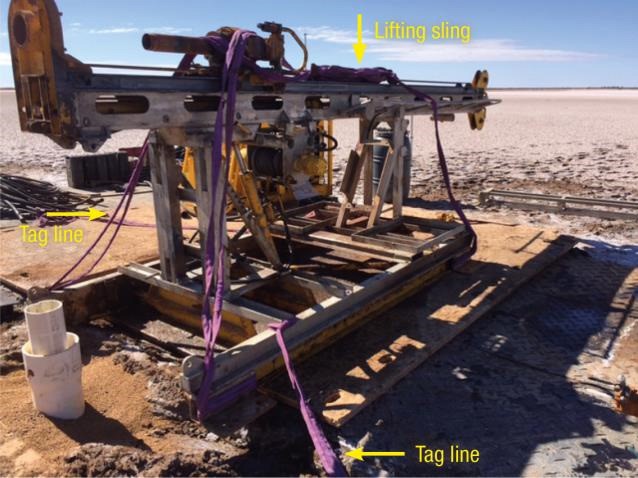 Drill rig showing four lifting slings looped around the rig’s base and the two fibre loop sling used as tag lines attached to opposite corners
