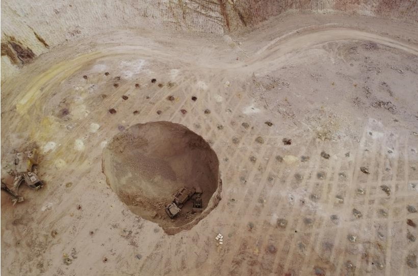 Open sinkhole with mine vehicles
