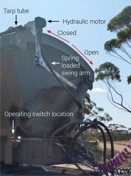 Road train trailer with swing arm attached to the tarp tube