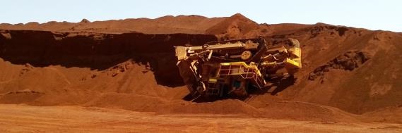 Overhung and undercut face when the edge collapsed, causing the dozer to slide down the face and roll onto its side
